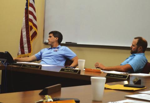 ERICK MITCHELL | DISPATCH RECORD Lampasas ISD Superintendent Dr. Chane Rascoe, at left, and Board of Trustees President Ryan Shahan listen to a presentation on facility needs and the financing options that could be available to address those.