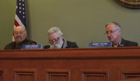 County commissioners Mark Rainwater, at left, and Lewis Bridges listen as County Judge Randy Hoyer asks questions during Monday’s meeting. ERICK MITCHELL | DISPATCH RECORD