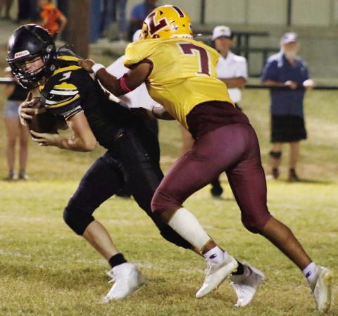Leonel Caso wrangles a Jonesboro runner during Friday’s contest. MASON HINES | DISPATCH RECORD