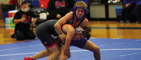 HUNTER KING | DISPATCH RECORD Laeton Kepler grapples with his opponent during the wrestling meet Wednesday night.