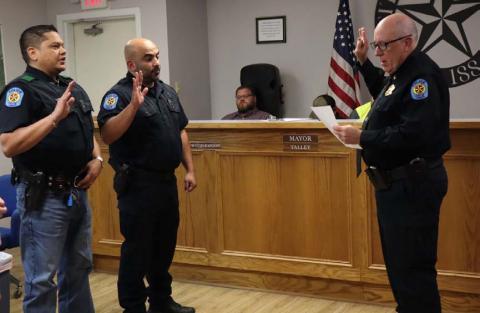 Lometa Police Chief Ronnie Strain swears in the police department’s newest officers. Jose Velazquez, at left, and Morrad Yasin, center, are now patrolling Lometa’s streets and serving the residents. CHERI JAY-WIENECKE | DISPATCH RECORD