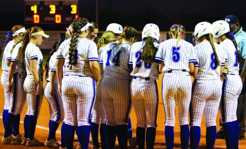 Members of the softball team surround home plate to celebrate a Madison Magilke home run against Marble Falls. HUNTER KING | DISPATCH RECORD