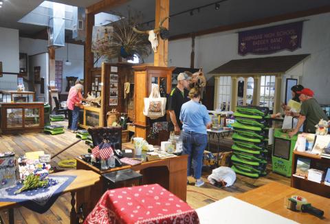 erick mitchell | dispatch record Museum volunteers are shown working to clear the gift shop area, which sustained damage May 10 when rain came through a leaky roof. Serve Pro representatives were on hand with their equipment to remove the water and excess moisture from the main floor of the building.