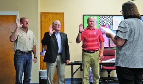 Lampasas Independent School District trustees elected in May take their oath of office on Monday. Trustees Randy Morris, at left, and Rob Borchardt, third from left, were re-elected without opposition to new three-year terms. Mickey Edwards, in center, was the voters’ choice to take the seat being vacated by retiring member Bill Brister. ERICK MITCHELL | DISPATCH REACORD