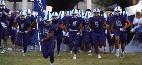 The Badgers break out of the tunnel for their season-opener against Elgin last week. HUNTER KING | DISPATCH RECORD