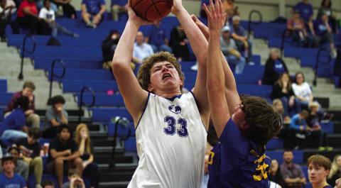 Beau Patterson goes up through contact for two of his 12 points against Lago Vista. HUNTER KING | DISPATCH RECORD