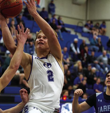 Haegan Oncken goes up between Jarrell defenders for a layup. HUNTER KING | DISPATCH RECORD