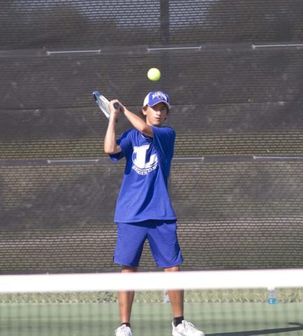 Tyler Ecker hits a backhand shot during a recent match against Ellison before district play begins on Saturday. HUNTER KING | DISPATCH RECORD
