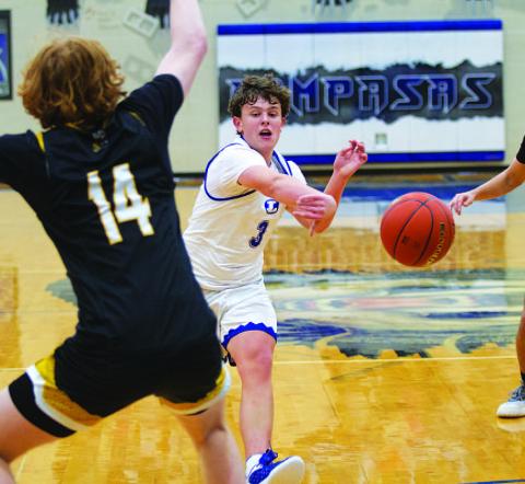 Aidan Nuckles passes the ball between defenders during a recent game agaisnt Gatesville. HUNTER KING | DISPATCH RECORD