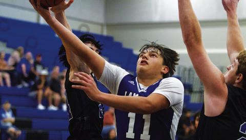 Dylan Polmanteer cuts through two Richland Springs defenders for a layup. HUNTER KING | DISPATCH RECORD