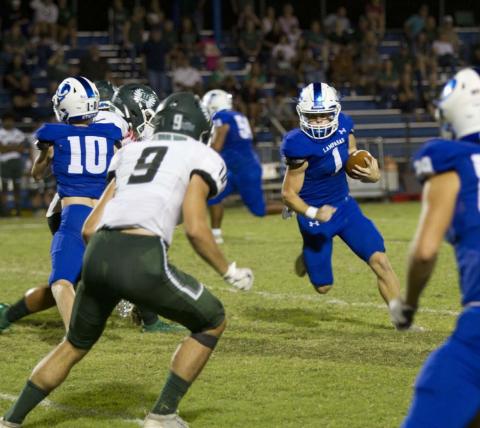 HUNTER KING | DISPATCH RECORD Luke Smith looks for a hole to run through as his blockers create space during the win over the Taylor Ducks last Friday.