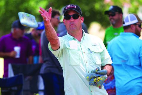 HUNTER KING | DISPATCH RECORD Evan Stubbs tosses a bag early in the cornhole tournament.