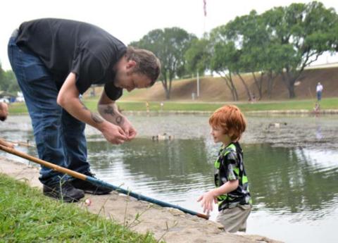Daniel Chapman prepares a cane pole for his son, Rory Chapman, 7, during the 2021 Spring Ho Festival fishing derby at W.M. Brook Park. file photo