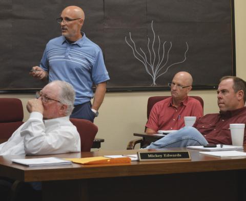 Lampasas ISD Assistant Superintendent Dana Holcomb, standing, discusses 2025 STAAR scores during Monday’s Board of Trustees meeting. Trustees also reviewed preliminary budget numbers for fiscal year 2025-2026 with Chief Financial Officer Shane Jones, seated at back. In foreground are board members Mickey Edwards, at left, and Board President Ryan Shahan. erick mitchell | dispatch record