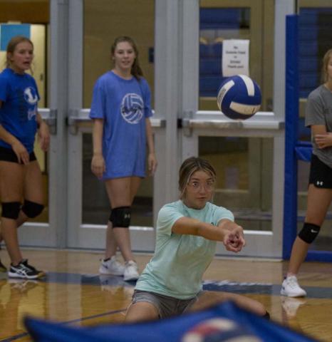 Lilee Hamill bends down for a pass during volleyball practice on Tuesday at the Lampasas High School gym. HUNTER KING | DISPATCH RECORD