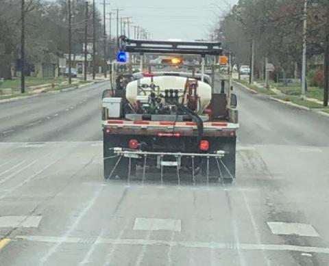A Texas Department of Transportation truck applies brine to a highway surface. The water-salt mixture creates a barrier that helps prevent ice from bonding with the roadway. COURTESY PHOTO