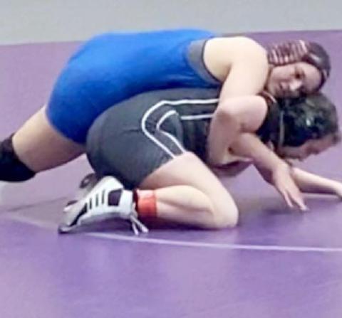 Lady Badger senior Mia Martell, left, placed third at the regional wrestling tournament in the 165-pound weight class on Saturday to qualify for state. LAURA MARTELL | COURTESY PHOTO