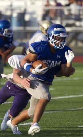 Levi Rivera carries the ball past a Marble Falls defender during the first scrimmage for the Badgers on Friday. HUNTER KING | DISPATCH RECORD