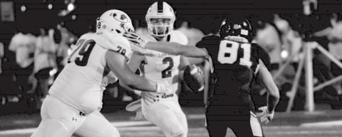 Ace Whitehead (2) keeps a play alive in the pocket as John Long (79) blocks against Stephenville. JEFF LOWE | DISPATCH RECORD