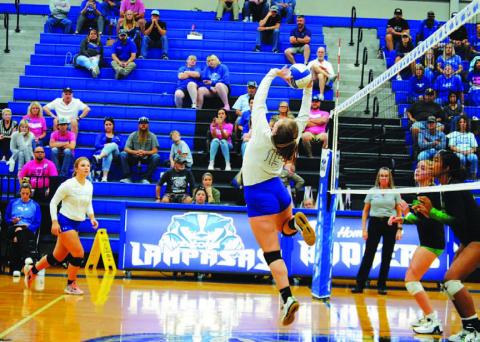 Ava Dowdy flips the ball over the net for a point against Burnet last Friday. HUNTER KING | DISPATCH RECORD