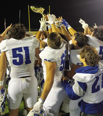 HUNTER KING | DISPATCH RECORD The Badgers hoist the bi-district championship trophy after beating Uvalde last week.
