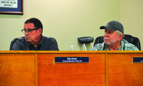 Kempner City Council members Rob Green, left, and Thomas Combs listen as audit information is presented in a council meeting. ERICK MITCHELL | DISPATCH RECORD