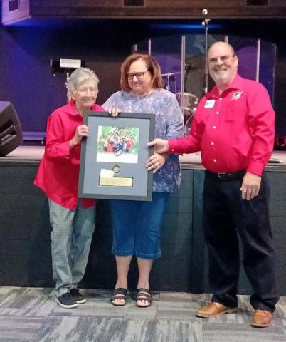 COURTESY PHOTO Receiving recognition from Area Coordinator Kirk Bailey of the Mid-TX Area for her 10 years of service as a drop-off leader at Church of the Hills Annex in Lometa is Margaret Williams, at left. She is accompanied by her daughter, Brenda Faubion. Operation Christmas Child is a project of Samaritan’s Purse that collects packed shoebox gifts for delivery to needy children around the world.