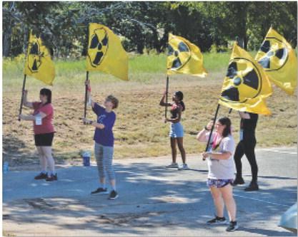 LHS color guard members wave flags with the nuclear symbol, an ode to the nuclear blasts that take place in the “Fallout” universe. ERICK MITCHELL | DISPATCH RECORD