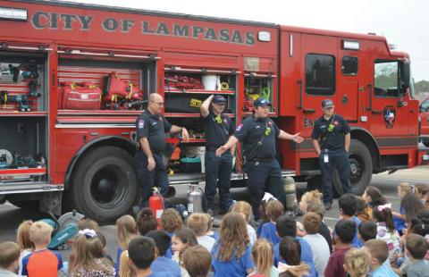 Lampasas Fire Department firefighters speak with students about fire safety during last Friday’s Hanna Springs Elementary School Safety Walk event. erick mitchell | Dispatch record