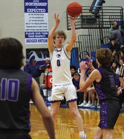 HUNTER KING | DISPATCH RECORD Peyton Sisson shoots over a defender for three of his 25 points Friday night.