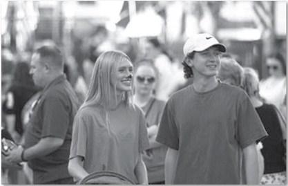 Leah Phillips, left, and Elijah Copeland smile as they walk around the square during the annual Squared Silly event last week. hunter king | Dispatch record