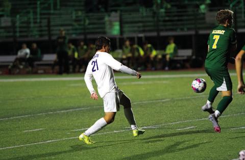 Juan Munoz picks out a pass to a teammate during the Badgers’ match against Academy. HUNTER KING | DISPATCH RECORD