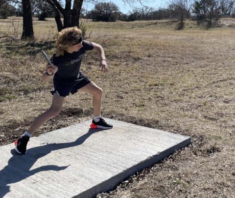 Eyan Skiles plays disc golf on the course behind New Covenant Church. JAQUELYN BODEN | COURTESY PHOTO