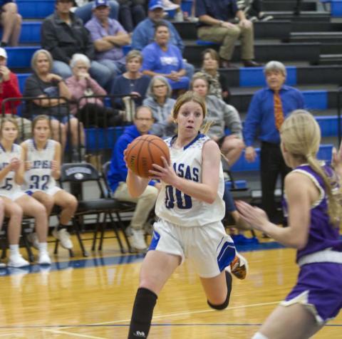 Aspen Wheeler drives toward the bucket against a Marble Falls defender on her way to completing an and-one basket to put the Badgers up by two points late in Tuesday’s game. HUNTER KING | DISPATCH RECORD