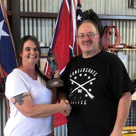Sons of Confederate Veterans Camp Commander Michael Oliver presents the first-place trophy, a statue of Stonewall Jackson, to Cheryl Ayers, winner of the Black Powder Turkey Shoot held May 3. Ayers is the wife of the SCV camp commander of the Williamson County Grays No. 502. She also is an expert seamstress who creates period uniforms and ladies dresses. courtesy photo