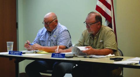 Commissioners Mark Rainwater, left, and Shad Hill review agenda materials at Monday’s Commissioners Court meeting, held at the county annex conference room. The next regular meeting will return to the courthouse’s first-floor courtroom. ERICK MITCHELL | DISPATCH RECORD