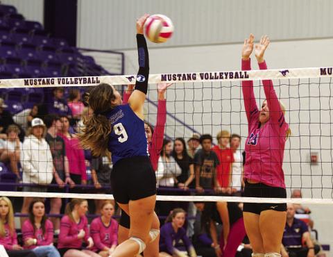HUNTER KING | DISPATCH RECORD Lilee Hamill spikes the ball past the Marble Falls block attempt for a kill.
