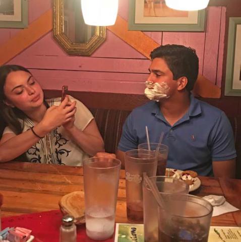 In 2018, after Erick Mitchell’s parents told the Magic Time Machine server it was his birthday, crew members serenaded him before covering his face in whipped cream. Mitchell’s wife, Emma, tries to capitalize on the moment with a photograph. courtesy photo