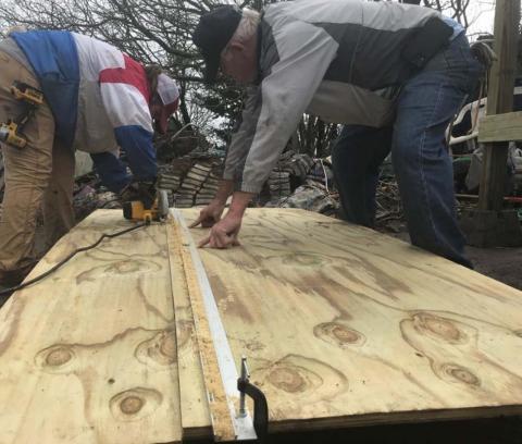 Lampasas High School student Saydie Smith, left, cuts plywood using a circular saw as David Jacobs looks on. MONIQUE BRAND | DISPATCH RECORD
