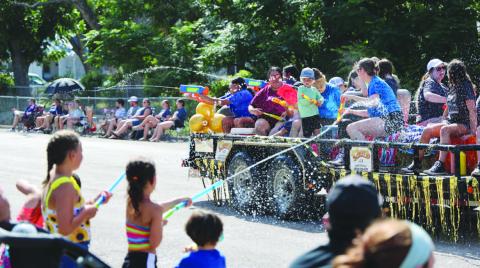 As is the tradition, Spring Ho Parade participants on floats and in the procession engage in a spirited water battle with the crowd. JOYCESARAH MCCABE | DISPATCH RECORD
