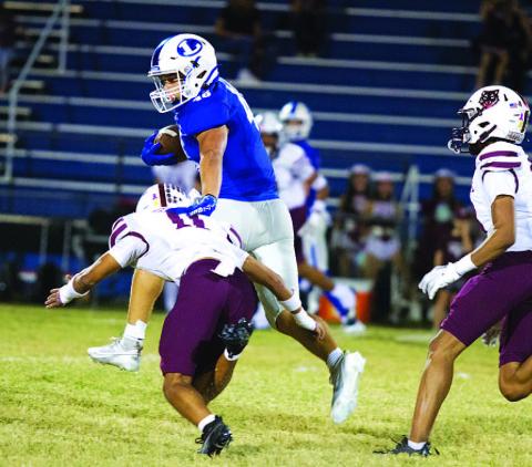 HUNTER KING | DISPATCH RECORD Haeagan Oncken makes a Davenport tackler miss as he runs up the middle of the field.
