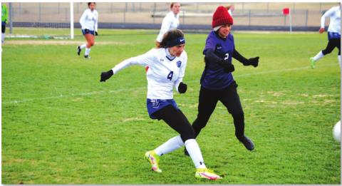 Nyla Long plays a ball down the line to a teammate during the Lady Badgers’ win over Florence last Friday. Long also scored a goal in the match. HUNTER KING | DISPATCH RECORD