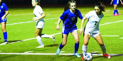 Lyndsie Perez challenges a Stephenville player for the ball during last Friday’s match. HUNTER KING | DISPATCH RECORD