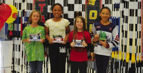 From left, Willow Gardner (first place), Violet Gude (second place) and Ryker Scott (third place) were the top competitors in last week’s derby. At right, Jordyn Burnett garnered the turtle award for having the slowest car in the race. ERICK MITCHELL | DISPATCH RECORD