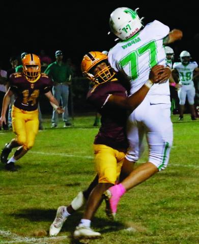 Leonel Caso (7) pressures the quarterback while Colton Whitehead (14) pursues the play MASON HINES | DISPATCH RECORD