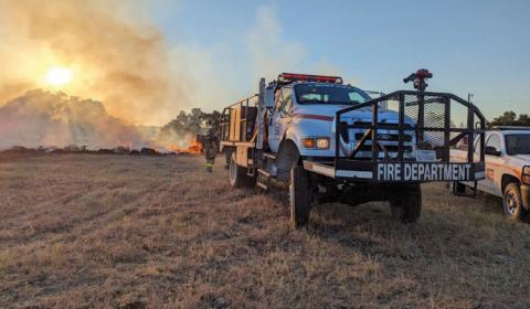 Flames stretch upward as volunteer firefighters work to stop the Spotted Opossum Fire from spreading and extinguish the flames. sharon watson | courtesy photo