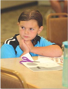 JOYCESARAH MCCABE | DISPATCH RECORD Chloe Phillips, 7, thoughtfully considers her plan for creating a pirate ship. Tuesday was her first time to attend one of the Lampasas Public Library’s STEAM events. The 10 a.m. event hosted about 18 area homeschoolers.