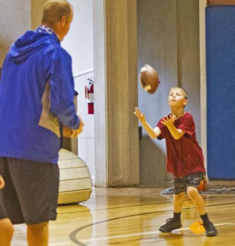 Football camp draws big turnout despite rain