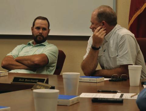 Trustees Ryan Shahan, left, and Rob Borchardt discuss options for a Lampasas ISD bond election that could go before voters in May. ERICK MITCHELL | DISPATCH RECORD