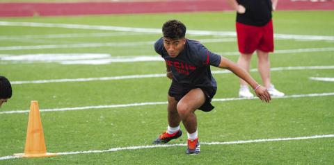 Juan Rodriguez runs through an agility drill at Tuesday’s SWAT workouts. HUNTER KING | DISPATCH RECORD